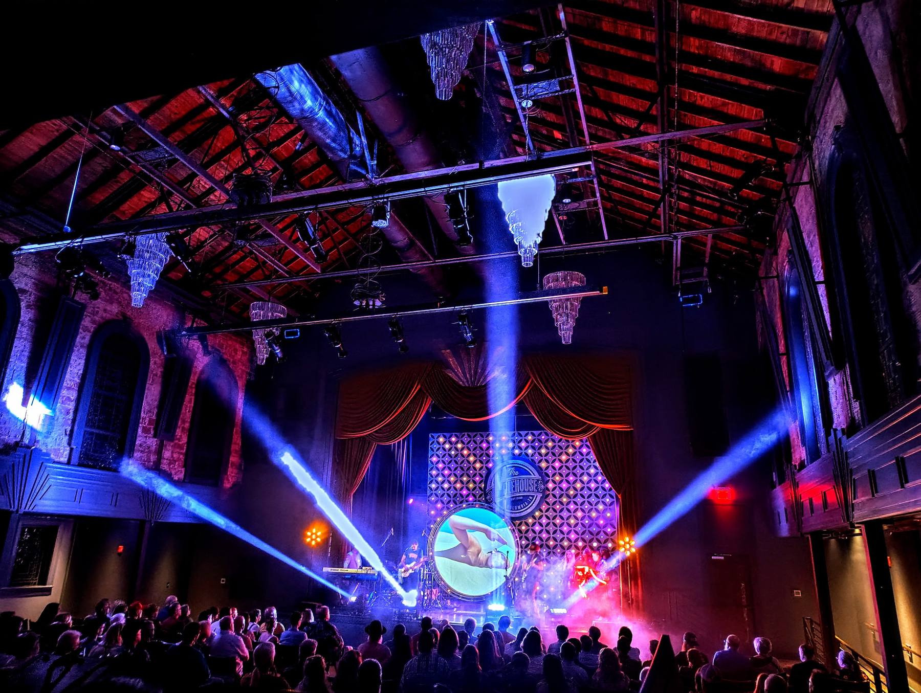 A packed Nashville venue lit by Pop Up Party 615 with moving-head beams, uplighting and an LED wall