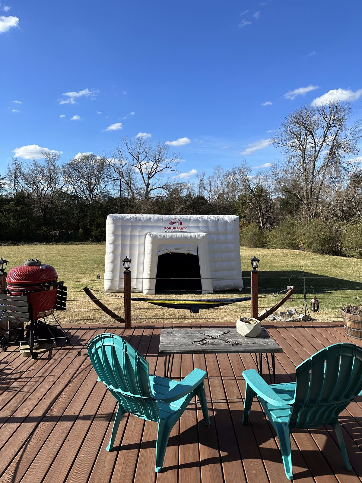 The pop-up party tent set up in daylight on a backyard deck