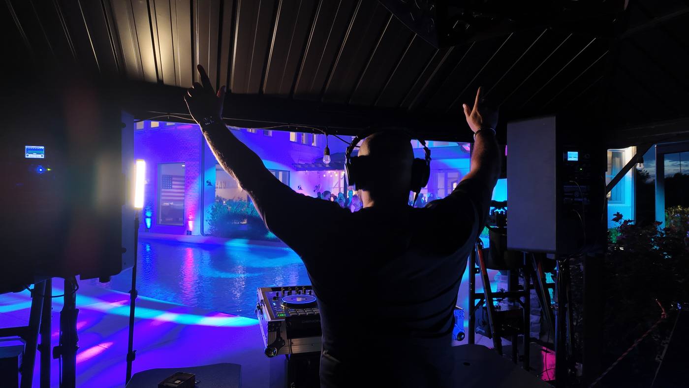 Inside the pop-up party tent at night, purple and blue lighting